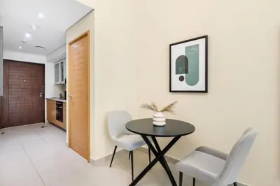 a dining room with a table and chairs at Silkhaus lovely studio with Downtown view in Boulevard central in Dubai