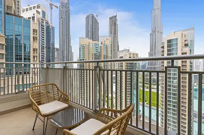 a balcony with chairs and a view of the city at Silkhaus with full Burj Khalifa & fountain view 1BDR in Downtown in Dubai