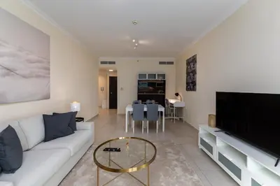 a living room with a white couch and a table at Marina Quays West, Dubai Marina - Mint Stay in Dubai