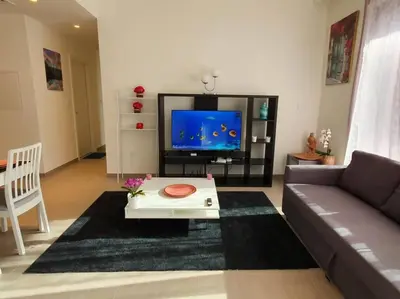 a living room with a couch and a tv at 2 Bedroom Apartment Available For Short Term Stay in Dubai