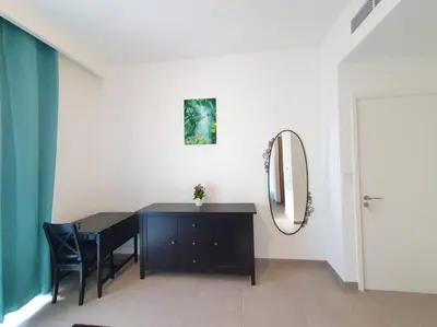 a room with a black desk and a mirror at 2 Bedroom Apartment Available For Short Term Stay in Dubai