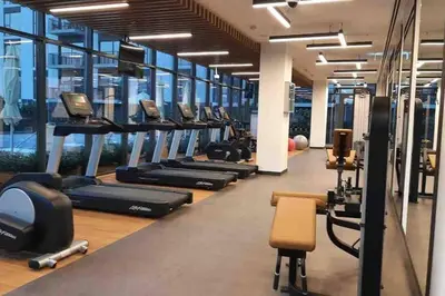 a gym with rows of treadmills and machines at 2 Bedroom Apartment Available For Short Term Stay in Dubai