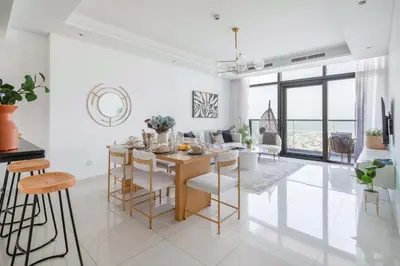 a kitchen and dining room with a table and chairs at Frank Porter - Paramount Midtown in Dubai