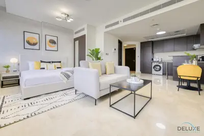 a living room with a white couch and a table at Refreshing Studio at Sky Gardens DIFC by Deluxe Holiday Homes in Dubai