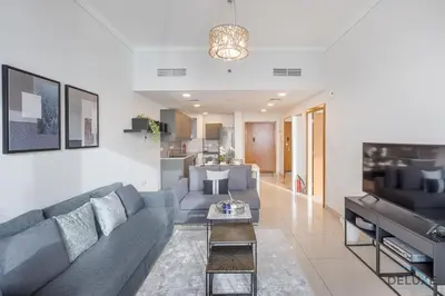 a living room with a couch and a table at Scenic 1BR at Ocean Heights Dubai Marina by Deluxe Holiday Homes in Dubai