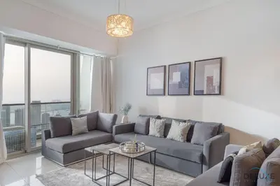 a living room with a couch and a table at Scenic 1BR at Ocean Heights Dubai Marina by Deluxe Holiday Homes in Dubai