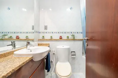 a bathroom with a toilet and a sink at White Sage - Luxurious Studio in JLT With City Skyline View in Dubai