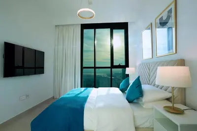 a bedroom with a large bed and a large window at Elegant Apartment with Direct access to Dubai Mall in Dubai