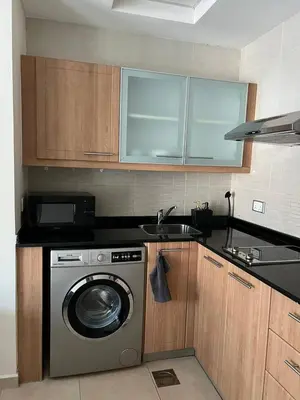 a kitchen with a washing machine and a sink at Cosy Studio in Marina in Dubai