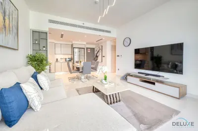a living room with a couch and a table at Exotic 2BR at Sunrise Bay Tower 1 Emaar Beachfront Dubai Marina by Deluxe Holiday Homes in Dubai