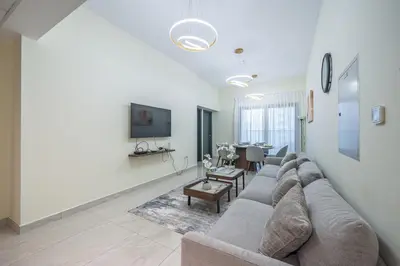 a living room with a couch and a table at Family-Sized 4BR Pool, Jacuzzi & Gym in Dubai