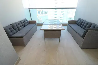 a living room with two couches and a coffee table at Cozy Family Apt Canal Vista Near Dubai Mall in Dubai