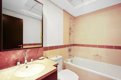 a bathroom with a sink and a tub and a toilet at Silkhaus cozy central studio in Downtown in 29 Boulevard in Dubai