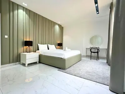 a bedroom with a large white bed and a mirror at STYLISH 2 BEDROOM SERVICE APARTMENT with SEA VIEW in Dubai