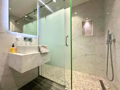 a bathroom with a sink and a shower at STYLISH 2 BEDROOM SERVICE APARTMENT with SEA VIEW in Dubai