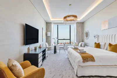a bedroom with a large bed and a living room at The Smart Concierge - Palm tower in Dubai