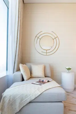 a room with a couch with a mirror on the wall at The Smart Concierge - Palm tower in Dubai