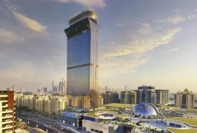 a tall building with a dome on top of it at The Smart Concierge - Palm tower in Dubai