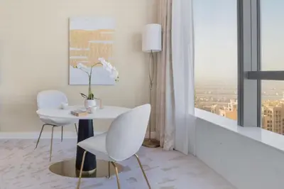 a room with a table and two chairs and a window at The Smart Concierge - Palm tower in Dubai