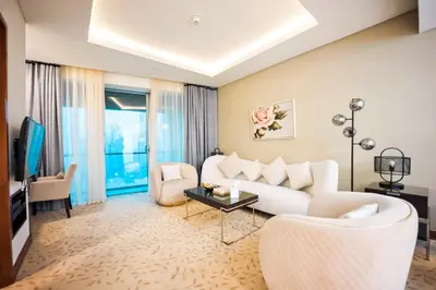 a living room with a white couch and a tv at FAHH Stunning 1 BHK at Address Dubai Mall in Dubai