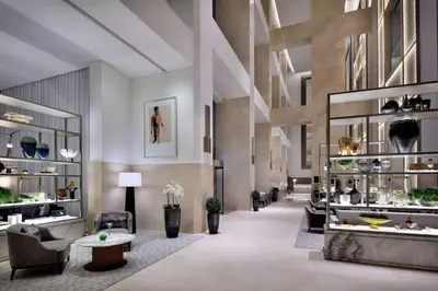 a lobby with couches chairs and tables and a room withartifacts at FAHH Stunning 1 BHK at Address Dubai Mall in Dubai