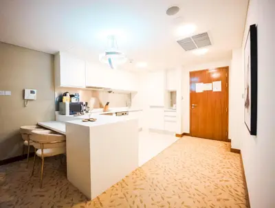 a kitchen with white cabinets and a counter top at FAHH Stunning 1 BHK at Address Dubai Mall in Dubai