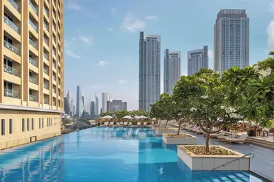 a large swimming pool in a city with tall buildings at FAHH Stunning 1 BHK at Address Dubai Mall in Dubai