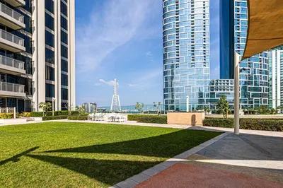 a park in a city with tall buildings at Sea View 2BD in new 52 42 tower Dubai Marina in Dubai