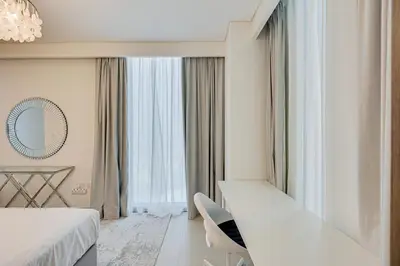a hotel room with a bed and a mirror at Sea View 2BD in new 52 42 tower Dubai Marina in Dubai