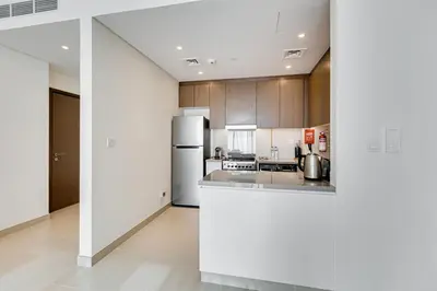 a kitchen with a refrigerator and a counter top at Sea View 2BD in new 52 42 tower Dubai Marina in Dubai