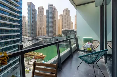 a balcony with chairs and a view of a city at Frank Porter - Silverene Tower B in Dubai