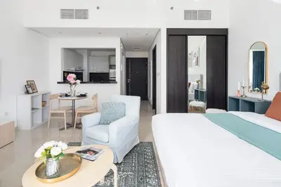 a bedroom with a large bed and a living room at Frank Porter - Silverene Tower B in Dubai