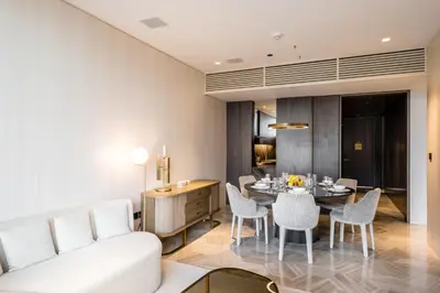 a living room with a white couch and a table at FIVE Palm Jumeirah Residences - Mint Stay in Dubai