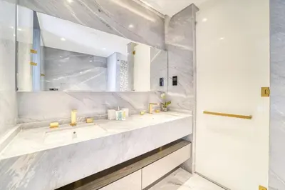 a bathroom with two sinks and a mirror at FIVE Palm Jumeirah Residences - Mint Stay in Dubai