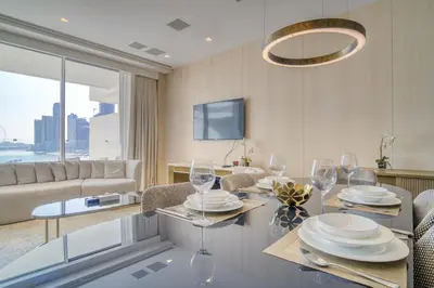 a dining room with a table with wine glasses at FIVE Palm Jumeirah Residences - Mint Stay in Dubai