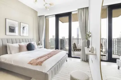 a bedroom with a large bed and a balcony at GuestReady - Magnificent heart of Downtown in Dubai