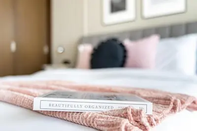 a book sitting on top of a bed at GuestReady - Magnificent heart of Downtown in Dubai