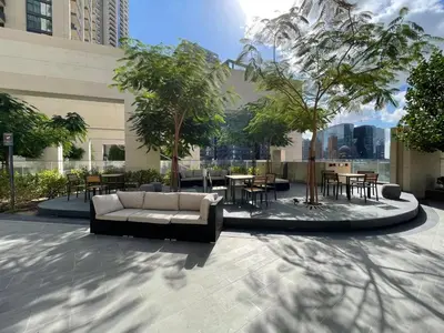 a couch in a courtyard with tables and chairs at GuestReady - Magnificent heart of Downtown in Dubai