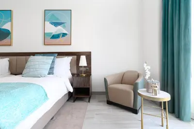 a bedroom with a bed and a chair at Avani Palm Burj-AlArab View from the pool in Dubai