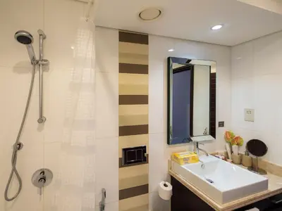 a bathroom with a sink and a shower at 2BR Dubai Burj View Downtown Skyline with Pool, Gym, & Parking in Dubai
