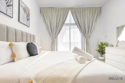 a bedroom with a large white bed with a window at Urban 1BR at Binghatti Stars Dubai Silicon Oasis by Deluxe Holiday Homes in Dubai