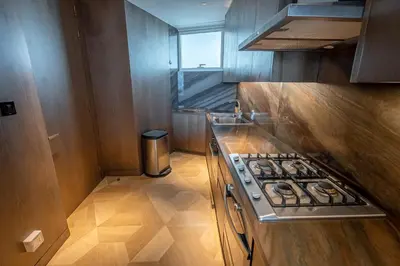 a small kitchen with a stove and a window at Daniels Stunning 2BR with Full Sea View at Five in Dubai