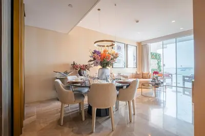 a dining room with a table and chairs at Daniels Stunning 2BR with Full Sea View at Five in Dubai