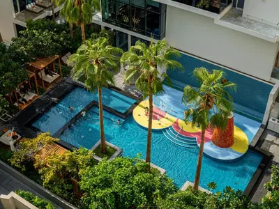an overhead view of a pool with surfboards and palm trees at Daniels Stunning 2BR with Full Sea View at Five in Dubai