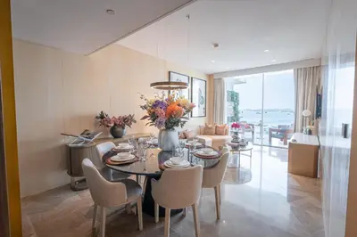 a dining room with a table and chairs at Daniels Stunning 2BR with Full Sea View at Five in Dubai