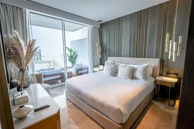 a bedroom with a large bed and a large window at Daniels Stunning 2BR with Full Sea View at Five in Dubai