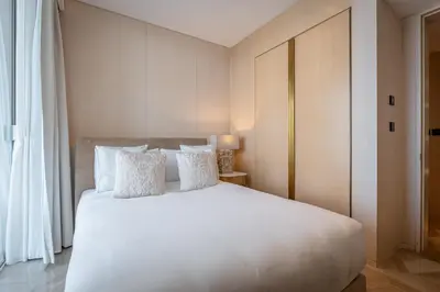 a bedroom with a large white bed with white pillows at Daniels Stunning 2BR with Full Sea View at Five in Dubai