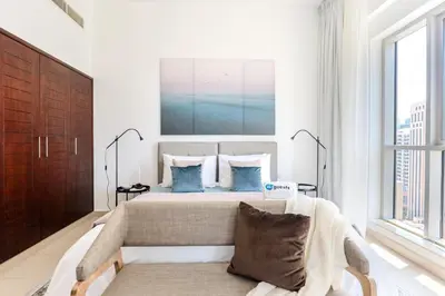 a bedroom with a bed and a couch in it at HiGuests - Amazing Apartment overlooking Burj Khalifa! in Dubai
