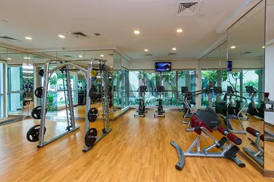 a gym with several treadmills and exercise bikes in it at HiGuests - Amazing Apartment overlooking Burj Khalifa! in Dubai