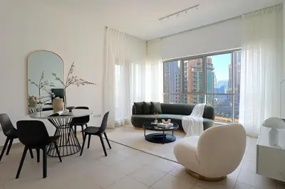 a living room with a couch and a table and chairs at HiGuests - Amazing Apartment overlooking Burj Khalifa! in Dubai